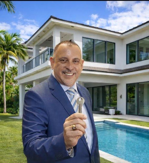 Freddy Soto smiling and holding a house key